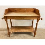 An antique pine wash stand with lower shelf, height 84cm, width 105cm (af).