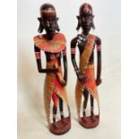 A pair of tall African tribal figures.