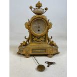A late 19th century French Ormolu mantel clock with Roman numerals to the circular dial and eight