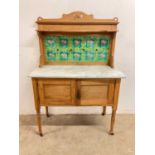 A marble topped pine wash stand with tiled back. Height 127cm Width 92cm x Depth 43cm