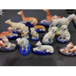 A group of Staffordshire animals, comprising nine pen holders, a standing dalmation, a pair of dogs,