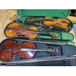 Three cased violins, for restoration.