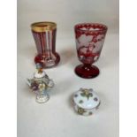 Two 19th century Bohemian ruby flash beakers, one with gilt decoration, the other with grape and