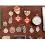 A collection of badges, medals, coins and other items - some silver