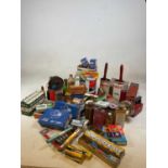 A collection of vintage tins and workshop finds including torches, car components, light bulbs,
