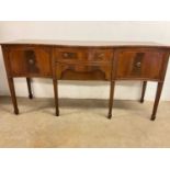 A serpentine fronted inlaid Edwardian style sideboard, with central drawer above hidden drawer