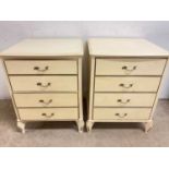 A pair of modern cream painted four drawer bedside cabinets.