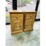 A pair of pine bedside cabinets with left and right opening doors with drawer above, height 67cm,