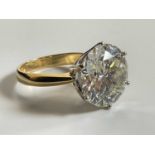 An impressive yellow metal diamond solitatire ring, the round brilliant cut stone approx. 7.40cts,