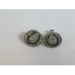 A pair of white metal emerald and diamond circular ear studs formed from a pair of buttons, diameter