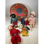 Two vintage felt toys, various dolls, and a parasol.