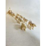 A rare Inuit walrus ivory hunting sledge with 7 dogs and a small polar bear