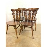 A set of four Ercol mid century fleur de lis kitchen chairs, unmarked and without labels, seat