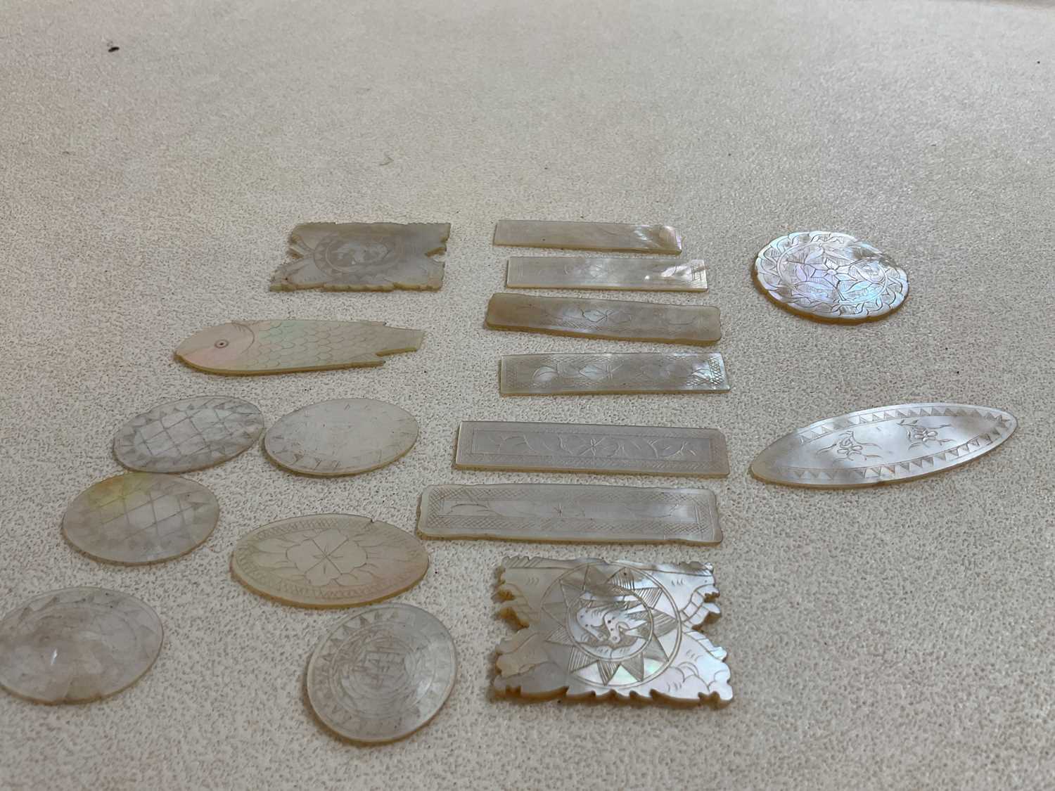 A small collection of 19th century Chinese mother of pearl gaming counters.
