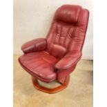 A red leather stressless chair and stool.