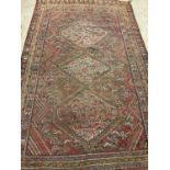 A hand knotted Senneh rug, 295 x 190cm.Dimensions: 295cm x 190cm