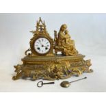 A late 19th century French gilt metal figural mantel clock with eight day movement and Roman