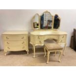 A cream painted four piece bedroom suite, comprising dressing table and stool, tallboy, and chest (