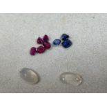 Standard VAT A group of loose gemstones, including a near pair of moonstones, three sapphires, and