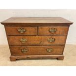 A small Georgian oak chest of drawers with two short over two long drawers, on bracket feet,