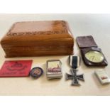 A small carved box, an Iron Cross, base metal vesta case, pocket watch, and badge.