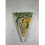 A decorative ceramic wall plaque featuring a bunch of grapes, height 54cm, width 43cm