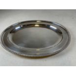 A large oval silver plated tray/platter with bead decorated rim, length 54cm.