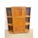 A golden oak 1930's Art Deco cocktail cabinet with drop-down door to bar, above cupboard flanked
