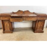 A late 19th/early 20th century flame mahogany pedestal sideboard, with lead lined cellerette