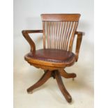 A 1920s oak swivel office chair