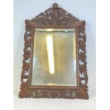 A French oak acanthus bevelled mirror, height 112cm, width 74cm.