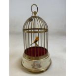 A 20th century brass bird cage automoton with yellow part feathered bird (needs some attention)