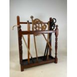 A mahogany stick stand with three compartments over metal drip tray, height 99cm, width 76cm,