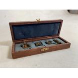 A cased set of four miniature marine instruments, comprising two drawer telescope, compass,