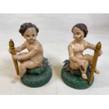 A pair of painted cast iron statues on wooden bases, probably European, height 24cm