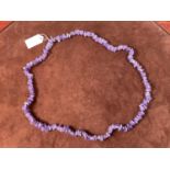 A rough cut amethyst necklace, length 80cm.