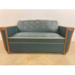 An Art Deco French Moustache sofa bed with green leather upholstery, height 79cm, width 162cm, depth