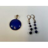 A lapis lazuli pendant set in 9ct gold and a pair of 9ct gold drop earrings