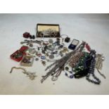 A quantity of costume jewellery including necklaces, brooches, earrings and some silver items