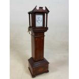 A miniature longcase clock in an inlaid mahogany case, the face marked Benton, Regent Street London,