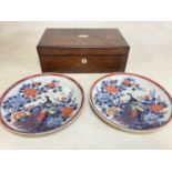 A pair of Imari plates (a/f with drill holes), diameter 30cm, and a rosewood writing box, 14 x 40