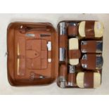 ASPREY; a gentleman’s pig skin leather travelling set including faux ivory backed brushes and