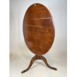 An early 19th century oak circular tilt-top occasional table, height 68cm, diameter 89cm.