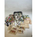 A quantity of cigarette cards and albums and postcards