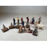 A group of mid 20th century carved wooden and painted Indian figures modelled as people in day to