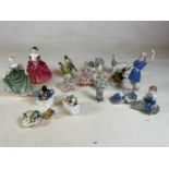 A collection of figures including Royal Copenhagen Girl 2273, Boy 153 and Cat 727, also two Royal