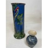 A Torquay ware vase decorated with bird in relief, height 26cm, and a small vase stamped to base