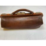 A small vintage leather 'Gladstone' bag complete with key, length 40cm
