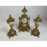 A decorative reproduction brass three piece clock garniture with Arabic numerals to the circular