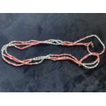 A coral and pearl three strand necklace, length 60cm.